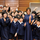 Melania Trump poses for a photo with students as they visit the Kyobashi Tsukiji elementary school in Tokyo, Japan, Nov. 6 2017.